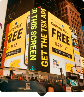Bright digital billboard advertising Costway Plus app promotion in Times Square, featuring vibrant colors and large text.